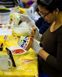 Woman painting pot